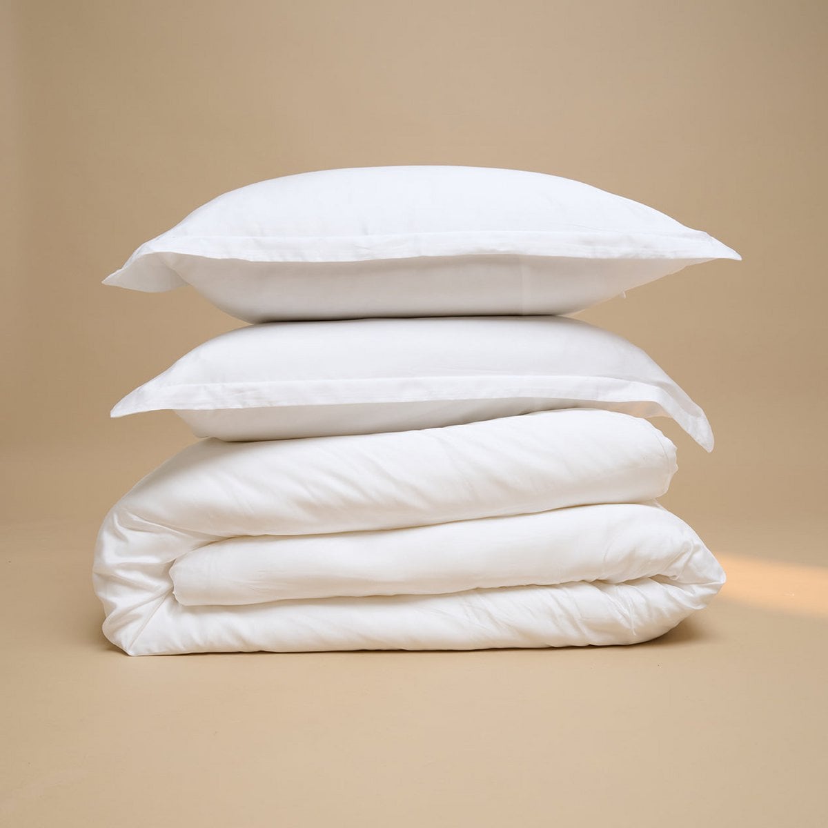 Tencel™ Sateen Duvet Cover and pillow in White, folded