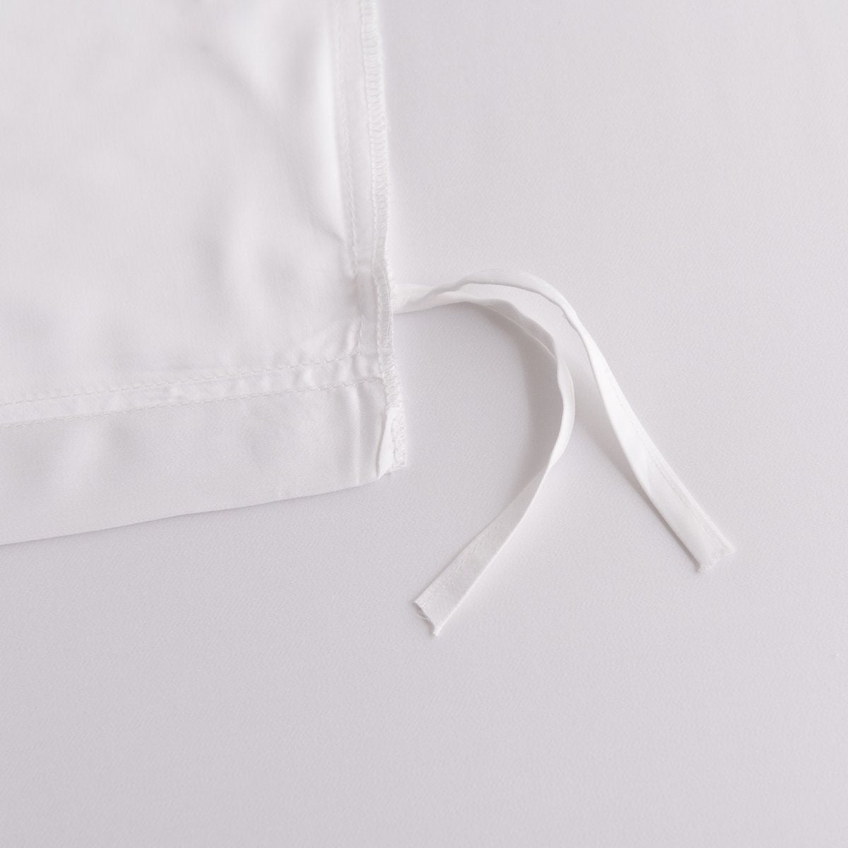 Close-up of the button/tag detail on the Coco White bamboo bedding