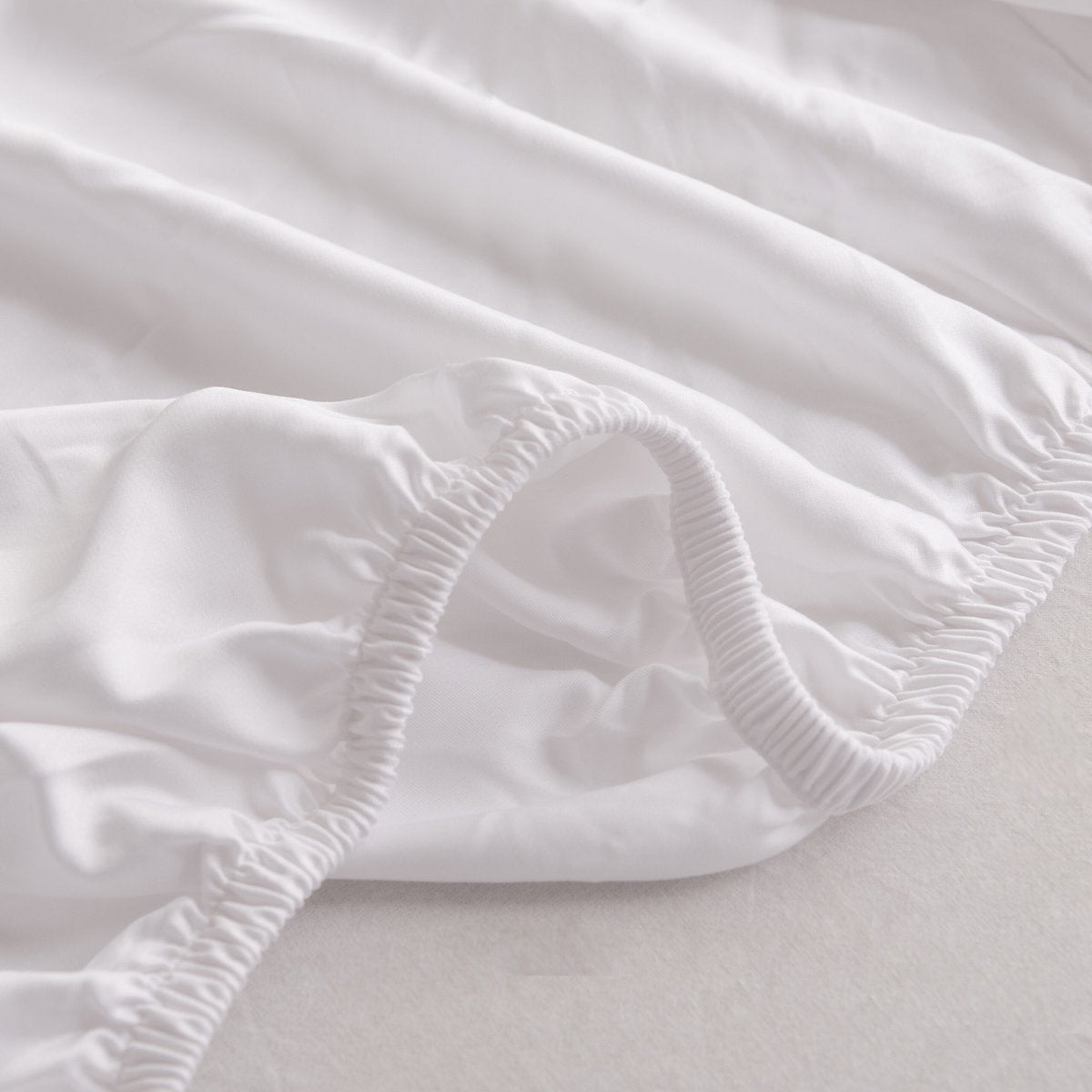 Coco White bamboo fitted sheet showing its soft, gathered elastic edge