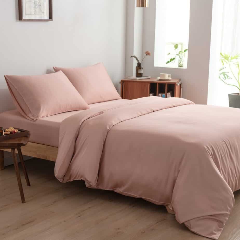 Cuddle Pink bamboo bedding set styled in a bedroom with a mirror