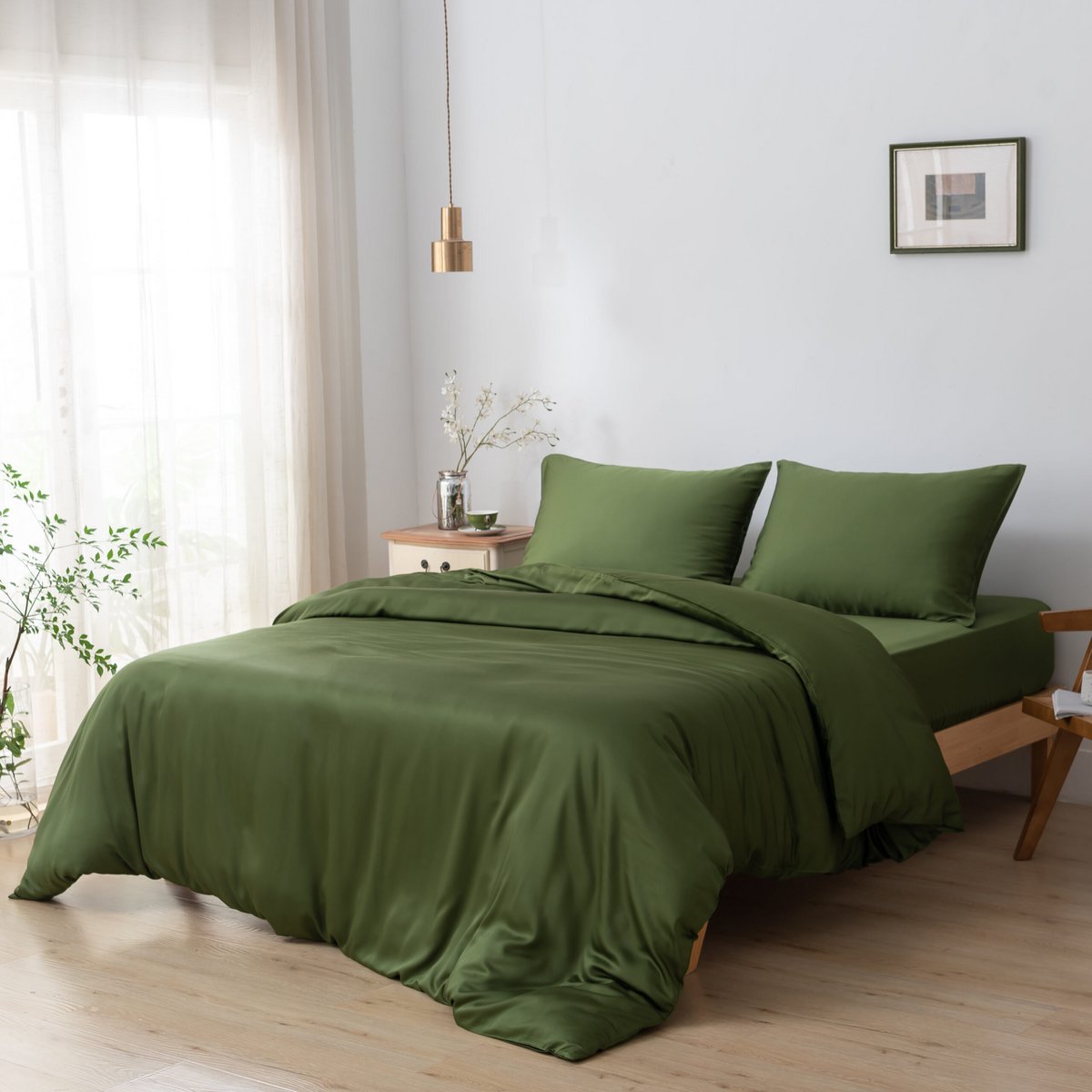 Deep Moss bamboo bedding set styled on a bed in a bedroom setting