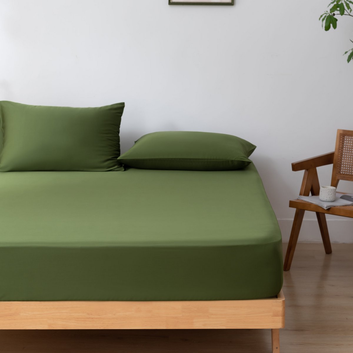 Deep Moss bamboo bedding set on a wood-framed bed