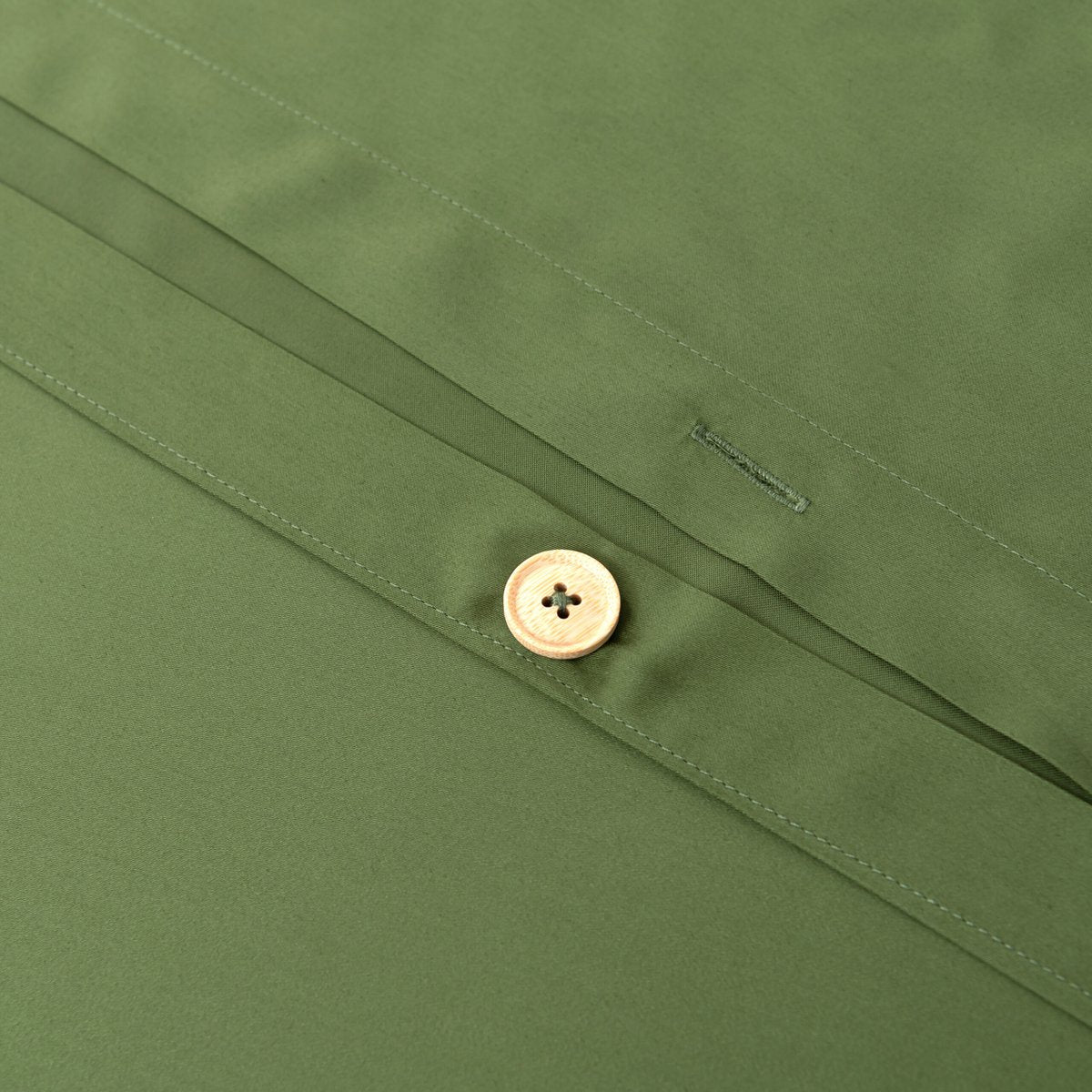 Close-up of the button/tag detail on the Deep Moss bamboo bedding