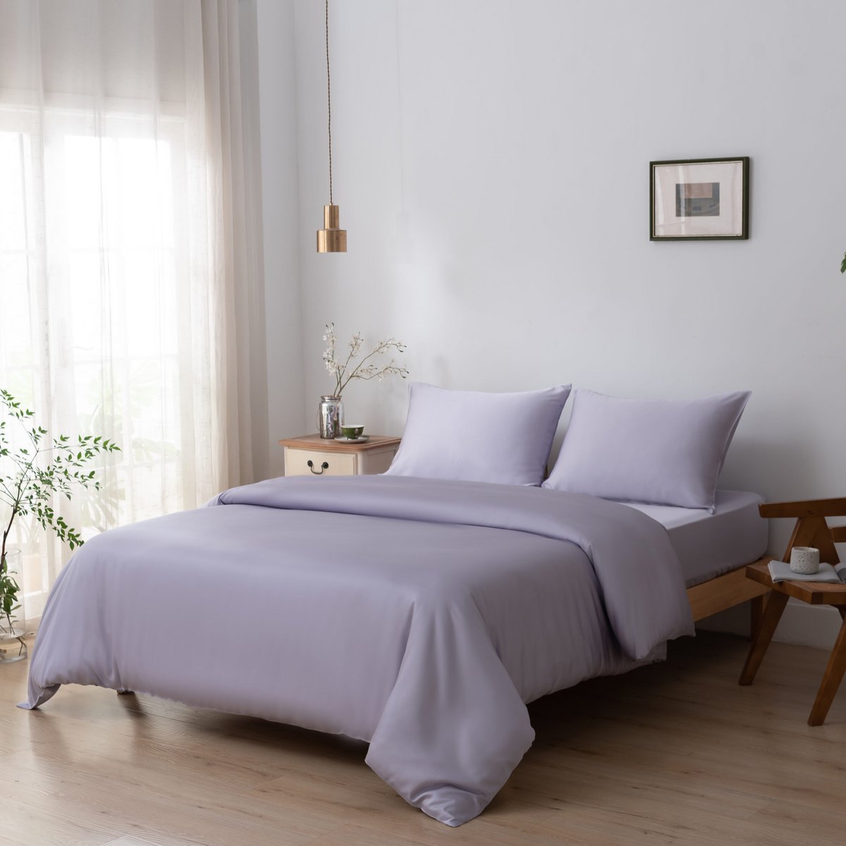 Lavender Mist bamboo bedding set styled on a bed by a window