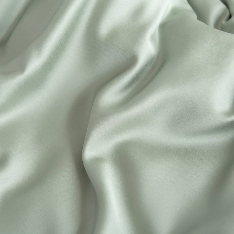 Folded Sage Green bamboo fabric showing its natural sheen