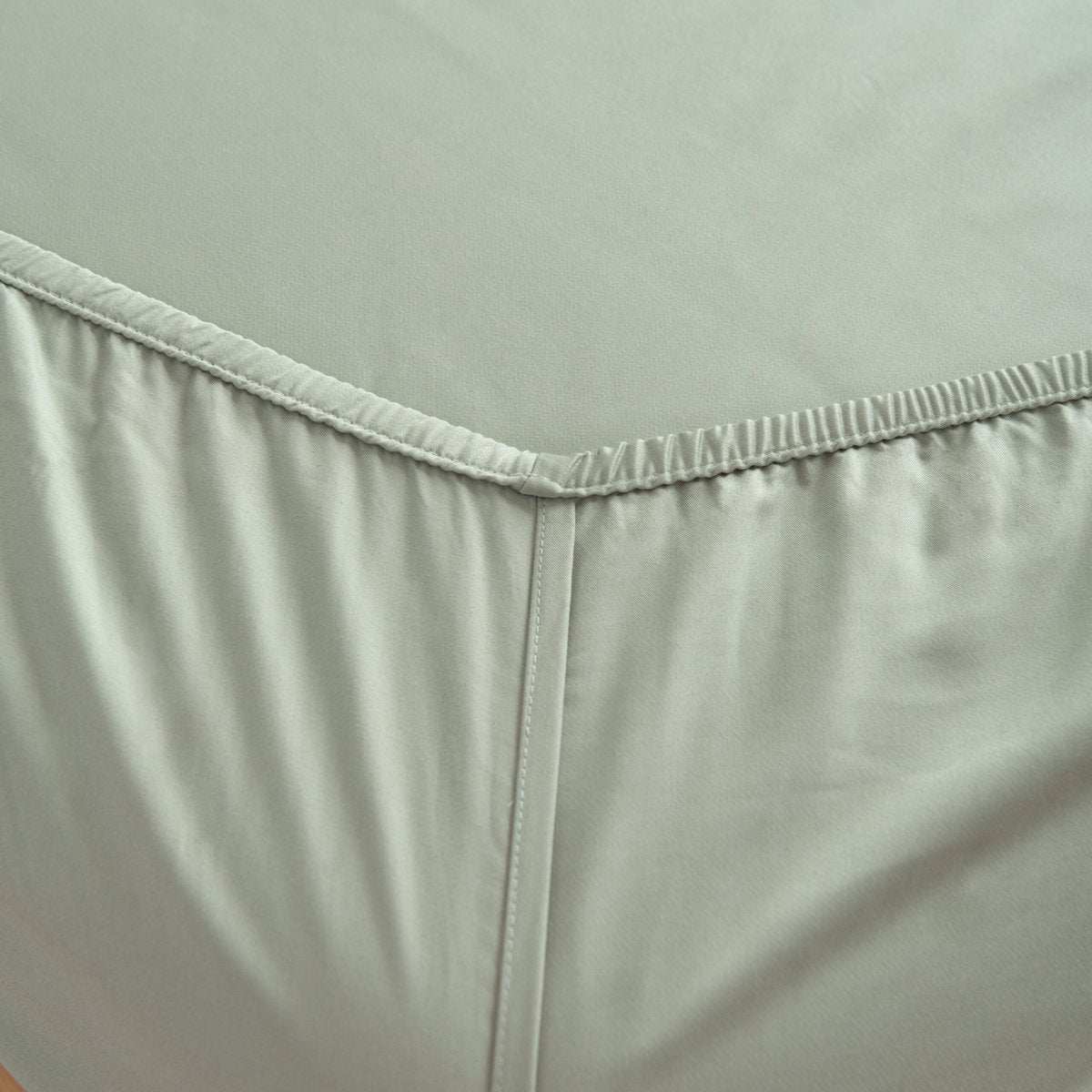Sage Green bamboo bedding set arranged flat on the bed