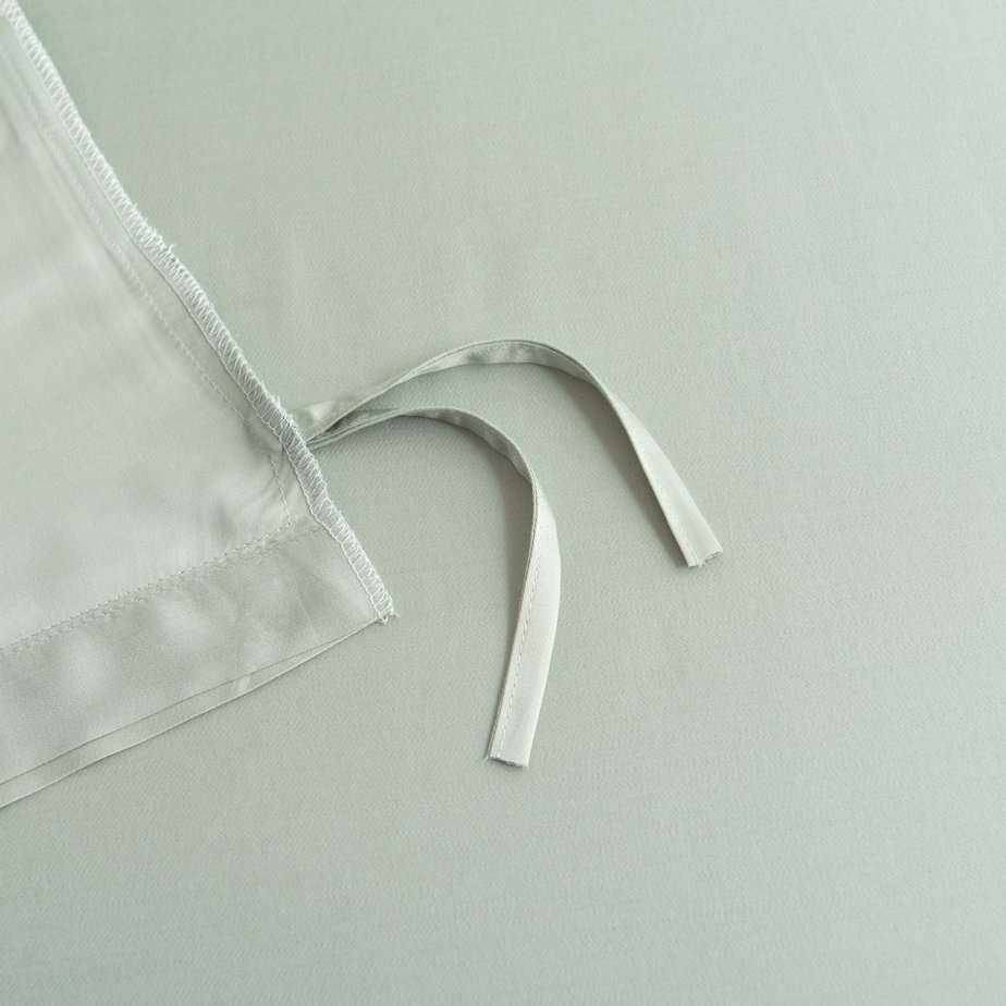 Close-up of a tie/closure detail on the Sage Green bamboo bedding