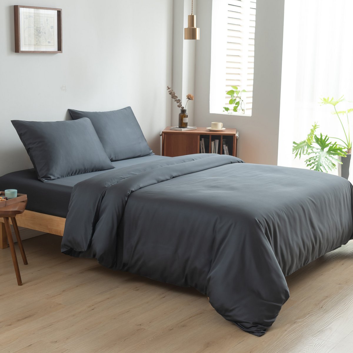 Space Blue bamboo bedding set on a bed by a window