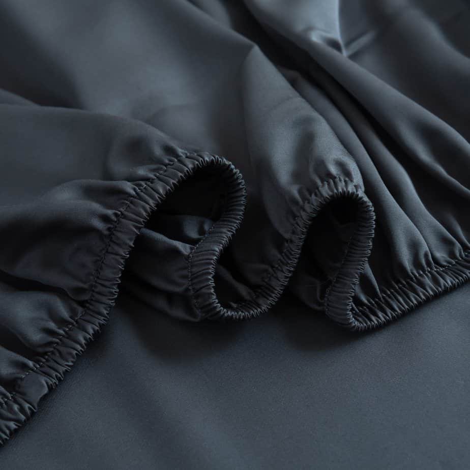 Folded stack of Space Blue bamboo bed linen