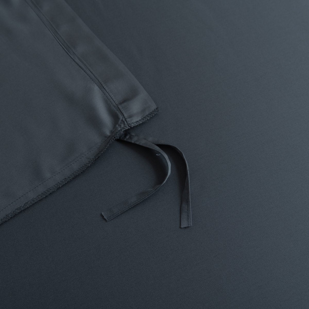 Close-up of a tie/closure detail on the Space Blue bamboo bedding