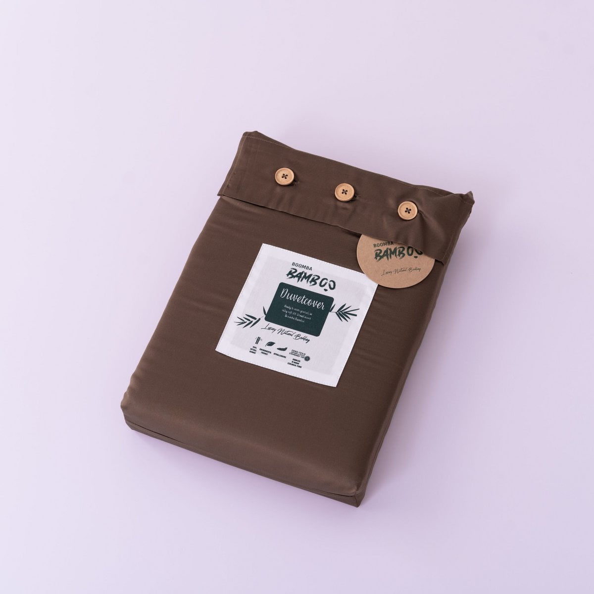 Folded Coffee Brown bamboo duvet cover with bamboo buttons fastened and the Boomba Bamboo branded label and hang tag attached