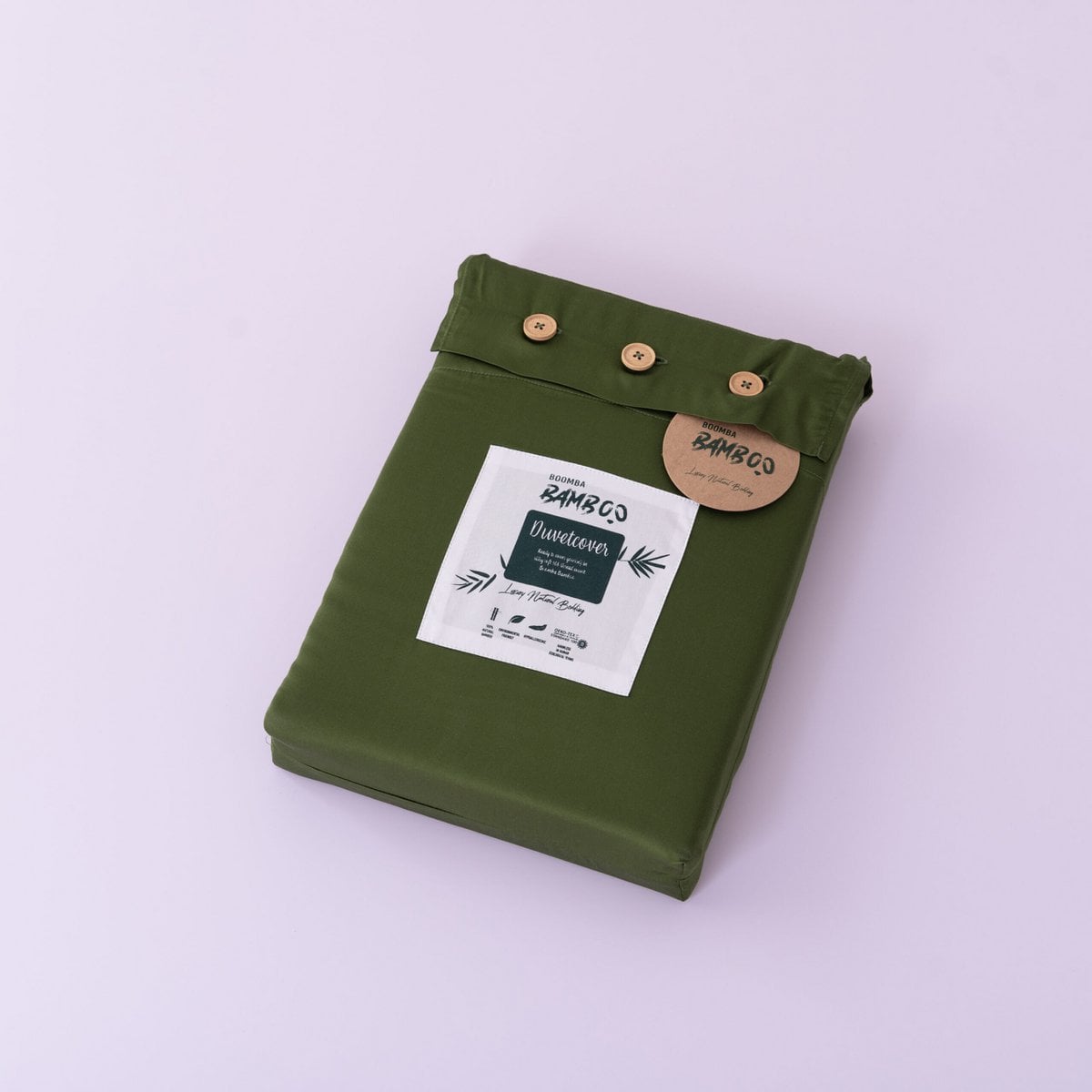 Folded Deep Moss bamboo duvet cover with bamboo buttons fastened and the Boomba Bamboo branded label and hang tag attached