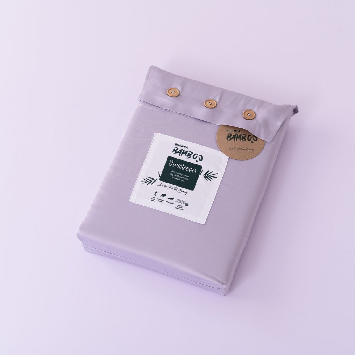 Folded Lavender Mist bamboo duvet cover with bamboo buttons fastened and the Boomba Bamboo branded label and hang tag attached
