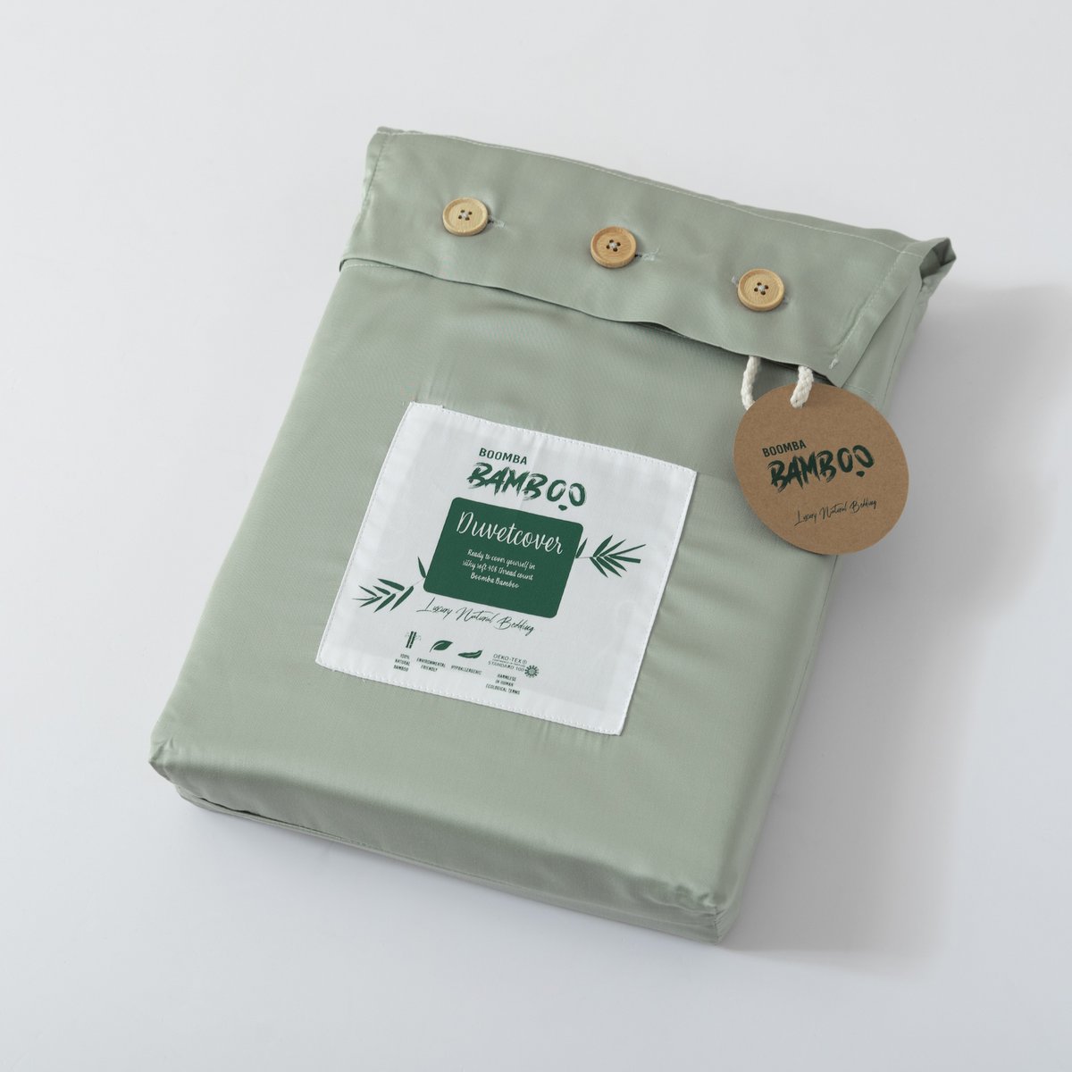 Folded Sage Green bamboo duvet cover with bamboo buttons fastened and the Boomba Bamboo branded label and hang tag attached