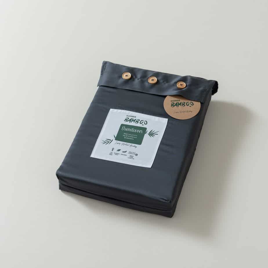 Folded Space Blue bamboo duvet cover with bamboo buttons fastened and the Boomba Bamboo branded label and hang tag attached