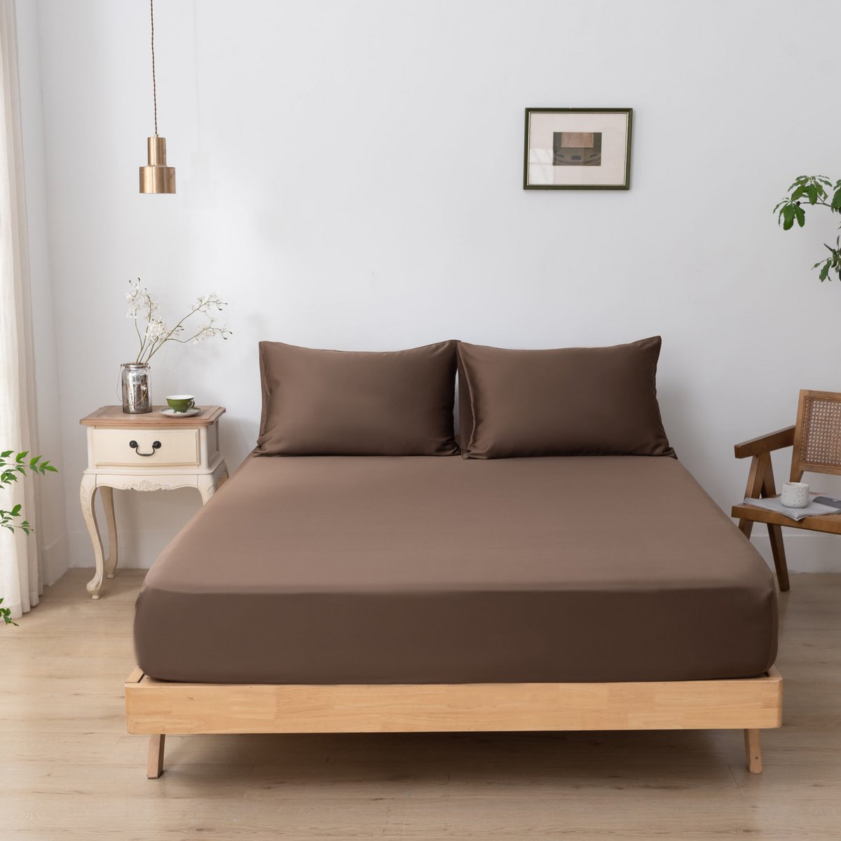 Coffee Brown bamboo fitted sheet on a made bed, shown straight-on with two matching pillows.