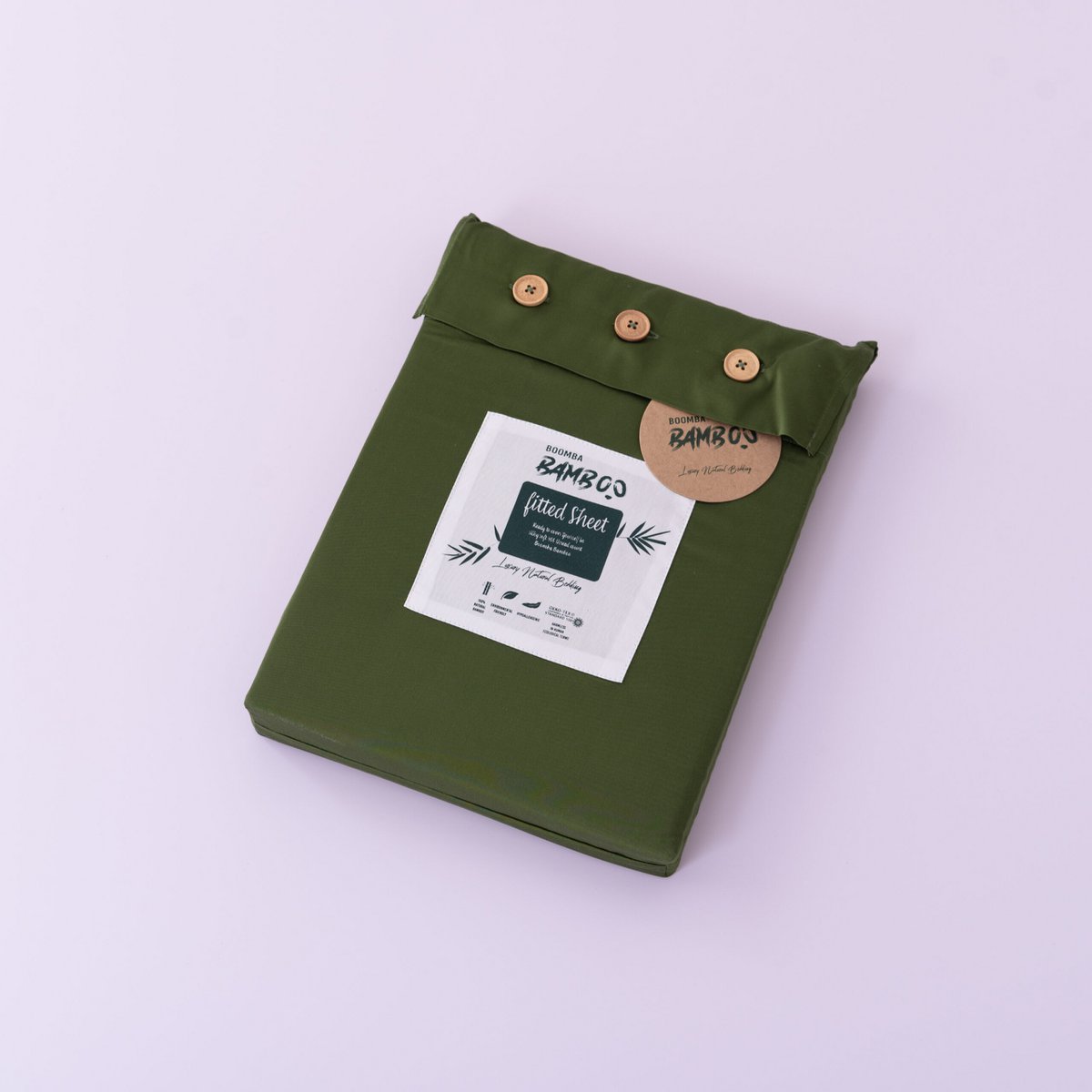 Deep Moss bamboo fitted sheet for mattress toppers folded and packaged with the Boomba Bamboo product label.