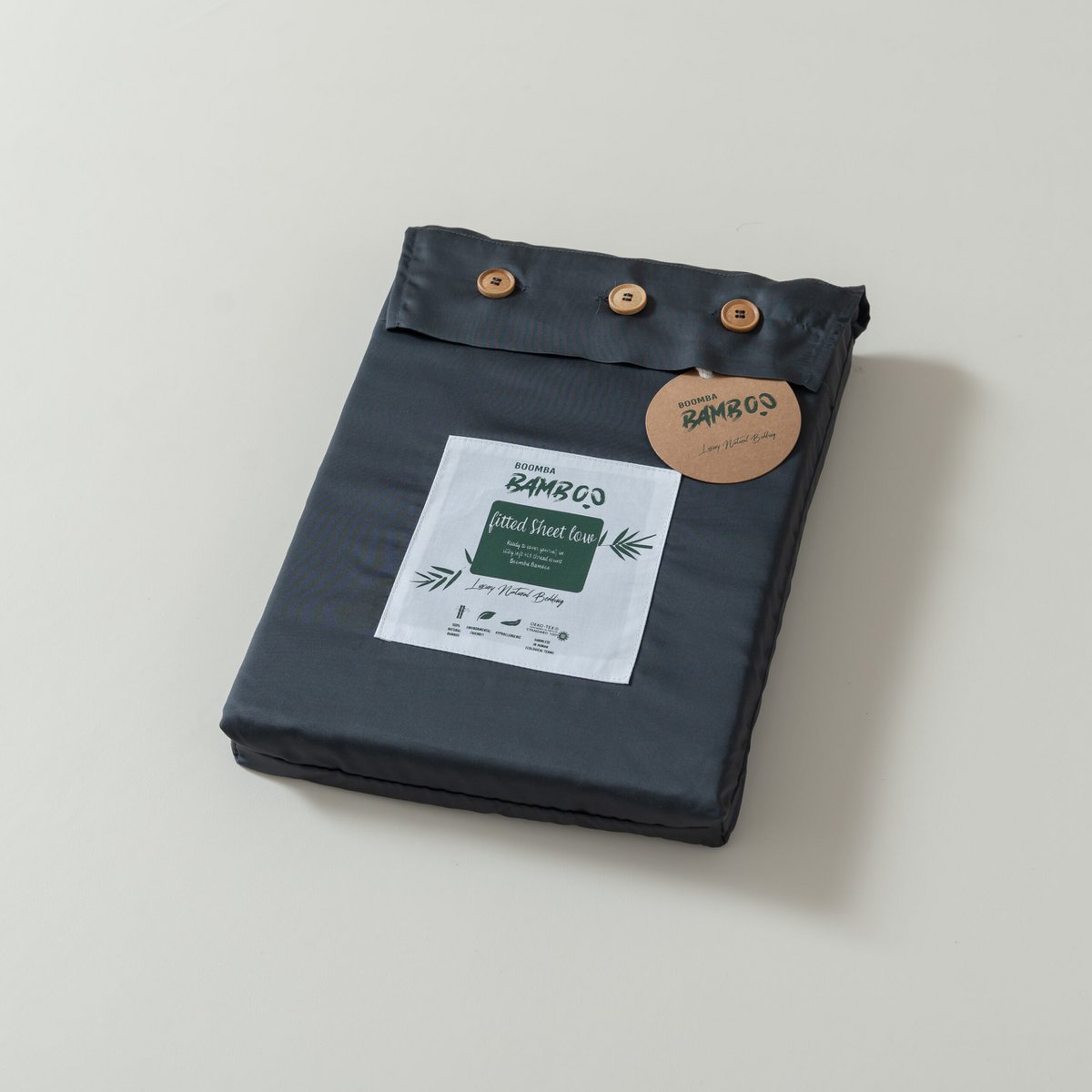 Space Blue bamboo fitted sheet for mattress toppers folded and packaged with the Boomba Bamboo product label.