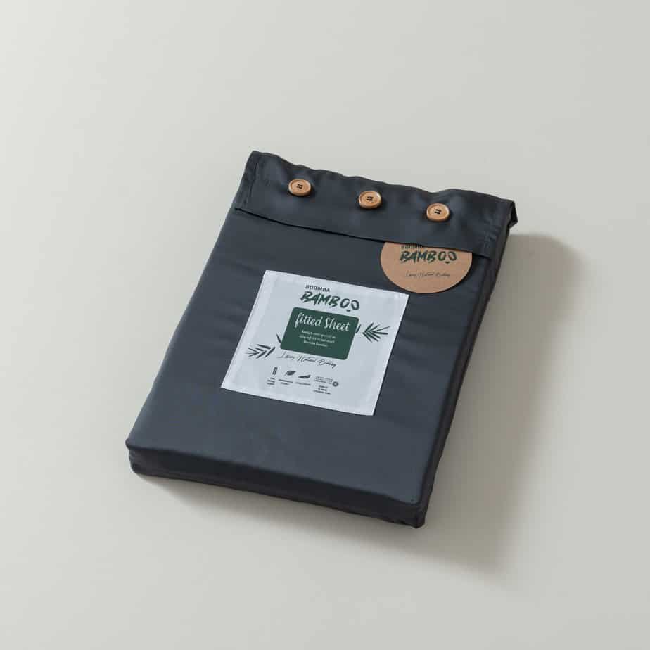 Space Blue bamboo fitted sheet folded and packaged with the Boomba Bamboo product label.