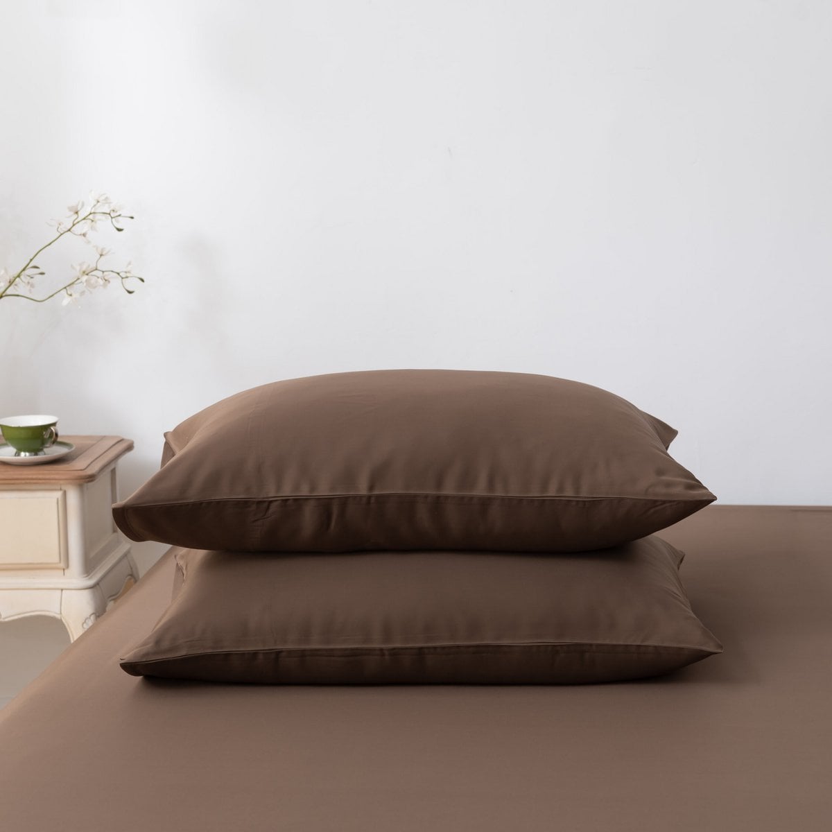 Coffee Brown bamboo pillowcases on a bed, wider view
