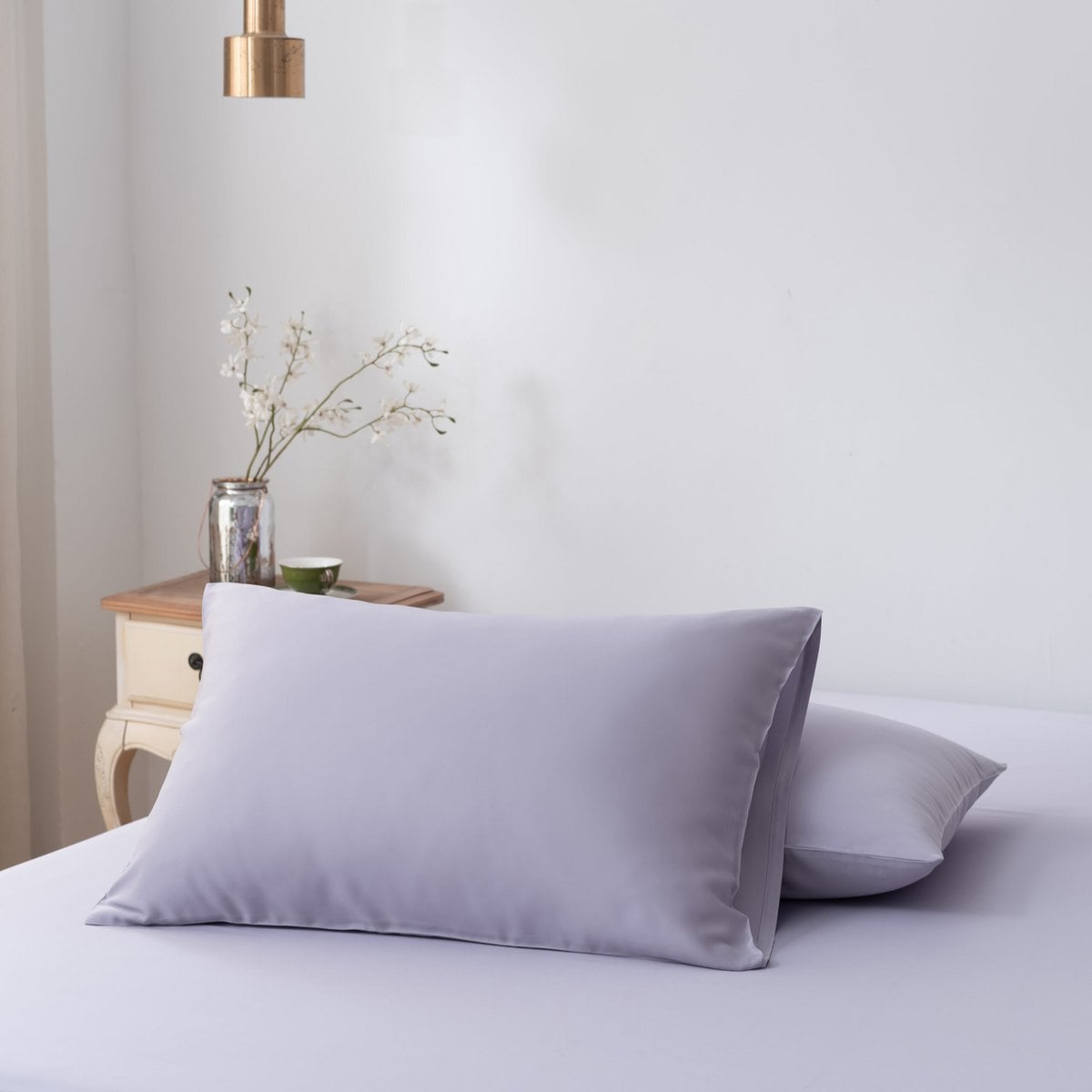 Lavender Mist bamboo pillowcase styled on a bed in a bedroom setting