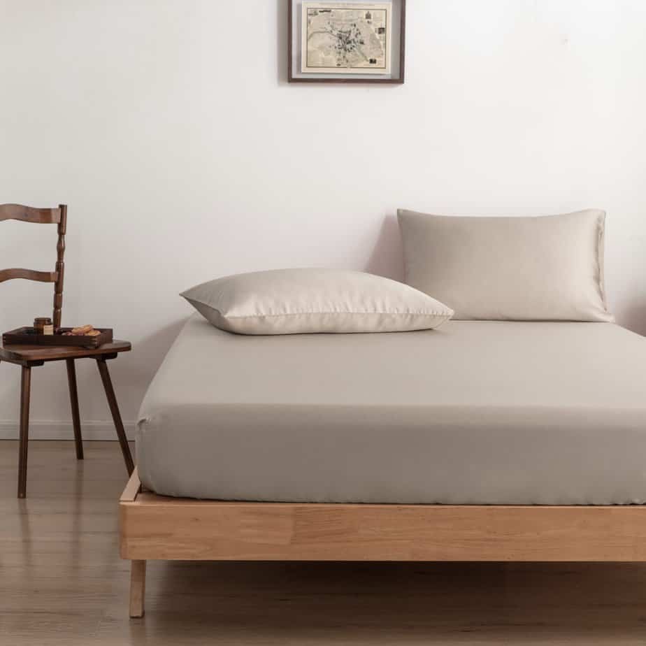Soft Taupe bamboo pillowcases on a wood-framed bed