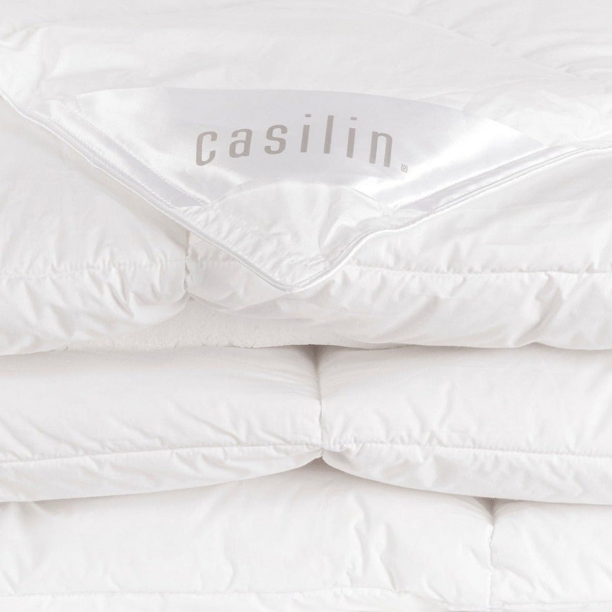 Close-up of the folded Casilin down duvet corner showing the branded label