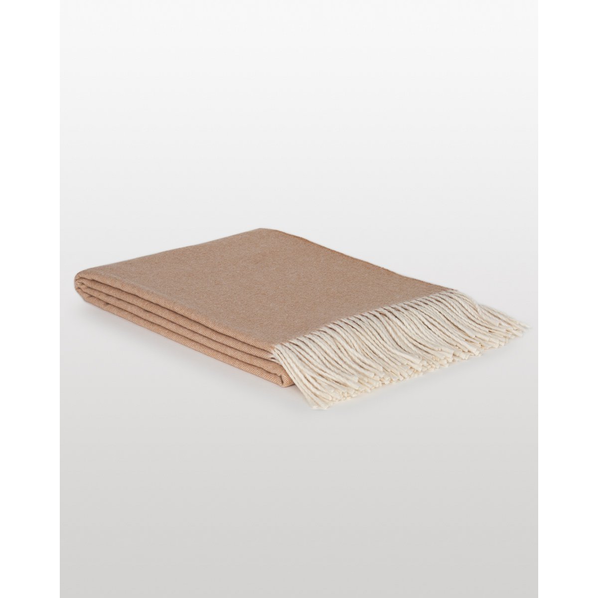 Merino & Cashmere Throw Blanket Tibet in beige styled in a room setting