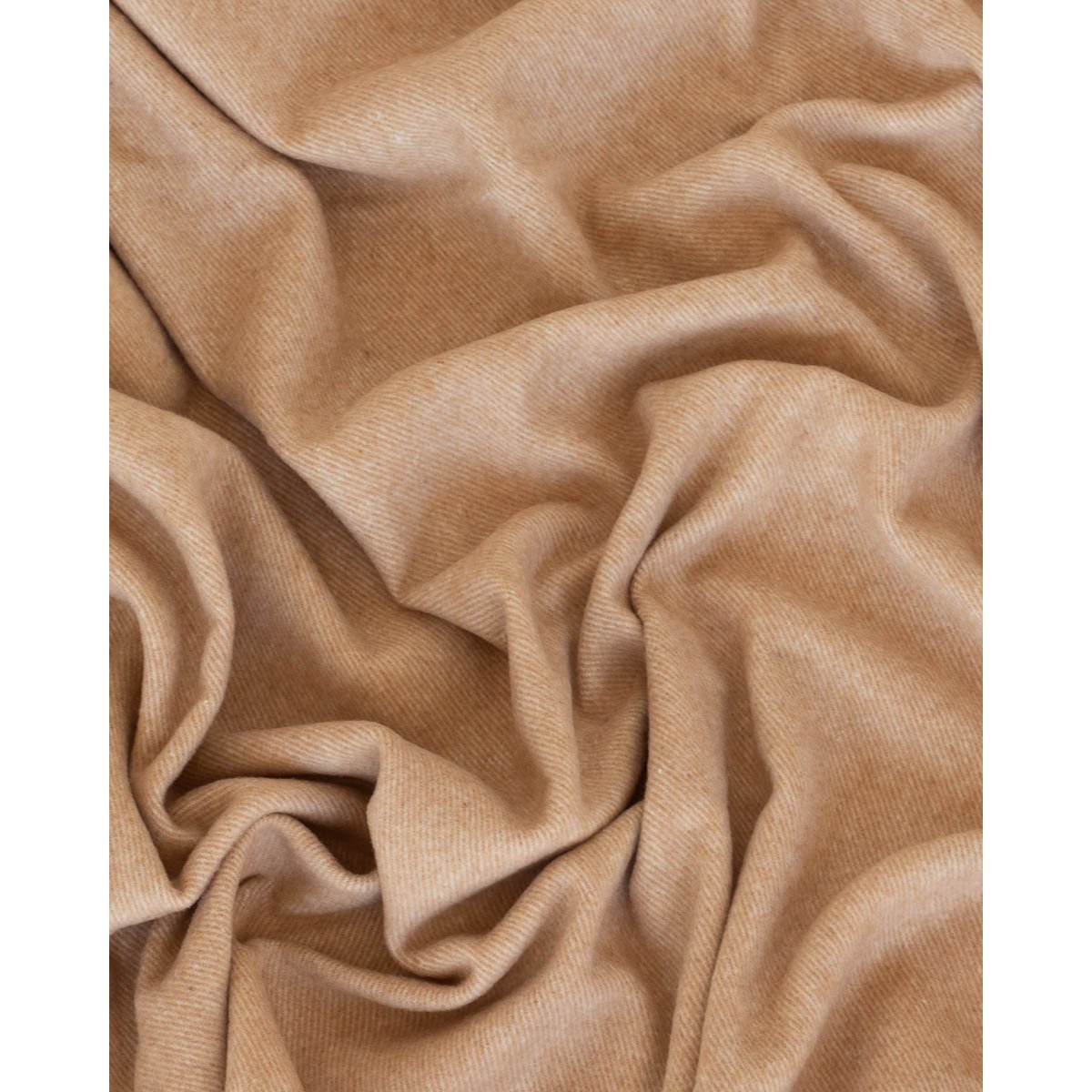 Close-up of Tibet throw's soft cashmere-wool texture in beige