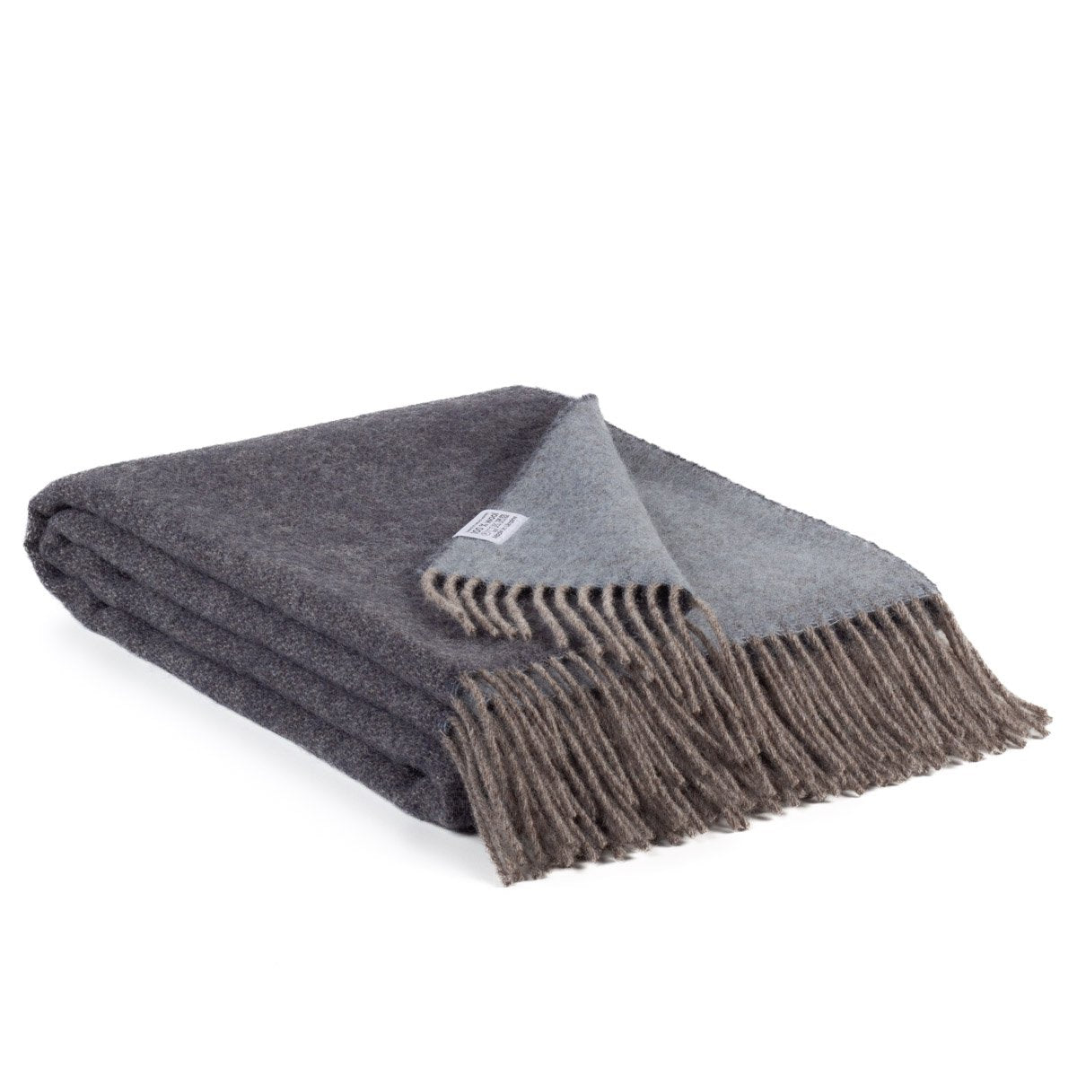 Reversible Wool Throw Blanket Denim draped over a sofa, showing plain blue motif