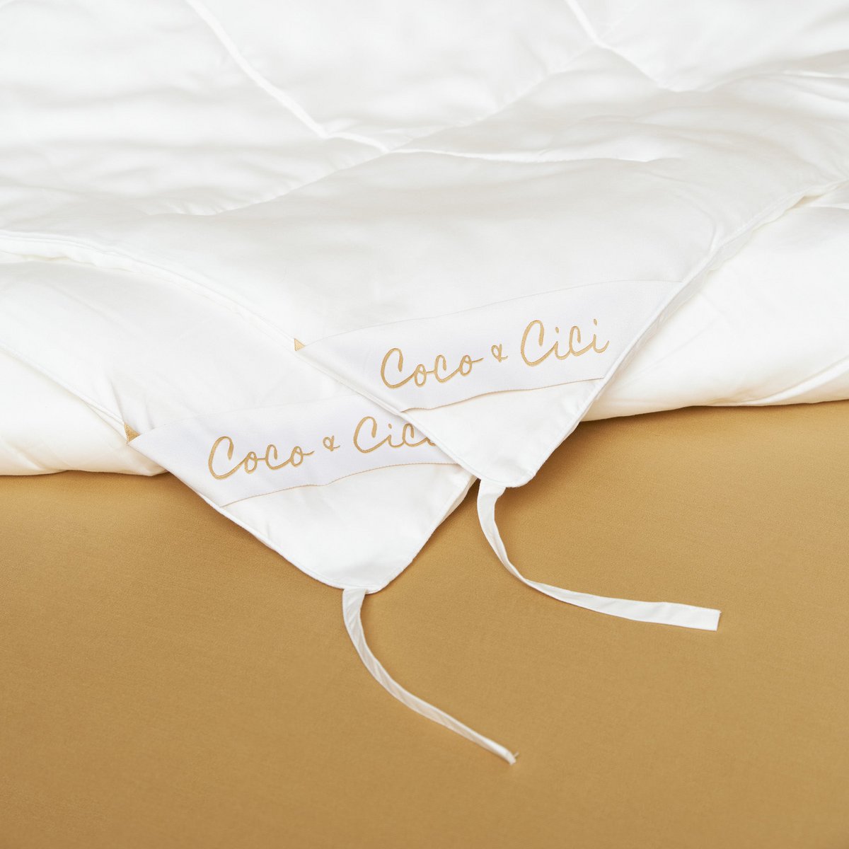 Tencel™ Four Seasons Duvet laid flat, showing the tie strings that join the two duvets