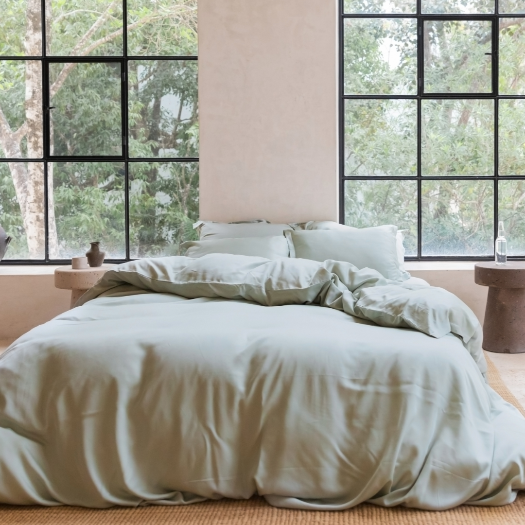 Tencel™ Sateen Duvet Cover in Gray Green styled on a bed by a window