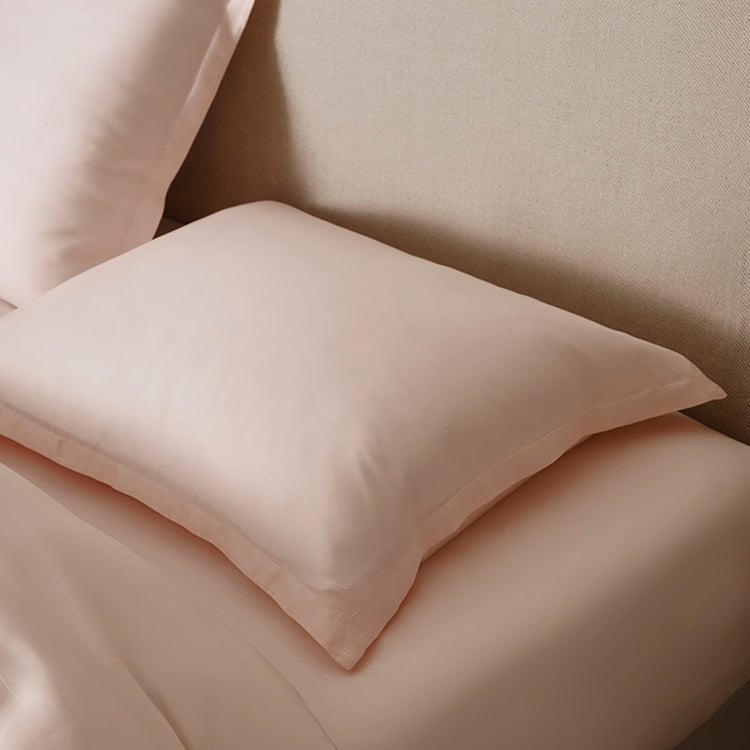 Close-up of pillows in the Tencel™ Sateen Duvet Cover set in Peach White