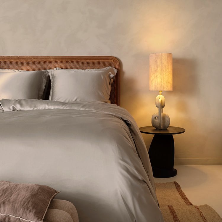 Tencel™ Sateen Duvet Cover in Taupe styled on a bed with warm lighting