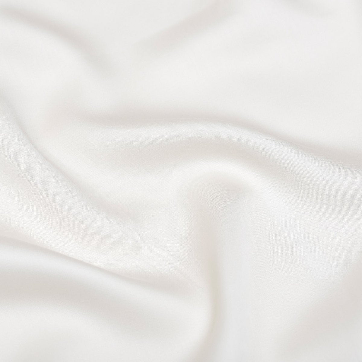 Close-up of off white Tencel Sateen fabric showing subtle sheen
