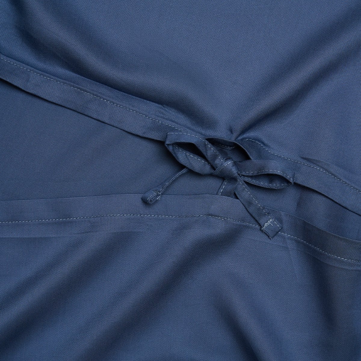 Close-up of a tied detail on the Tencel™ Twill Duvet Cover in Dark Blue