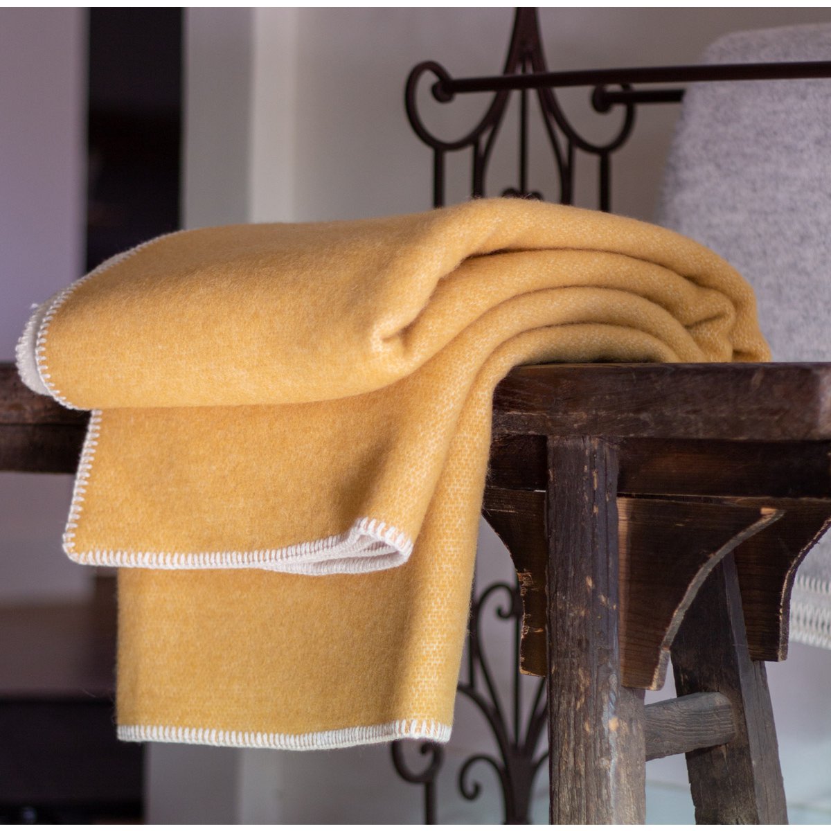 Woolen Bedspread Misted Yellow styled on a bed