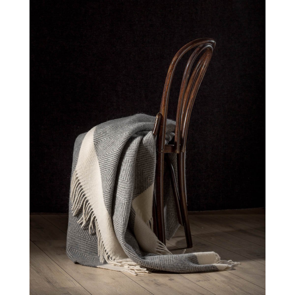 Wool Throw Blanket Florence in grey styled on a chair