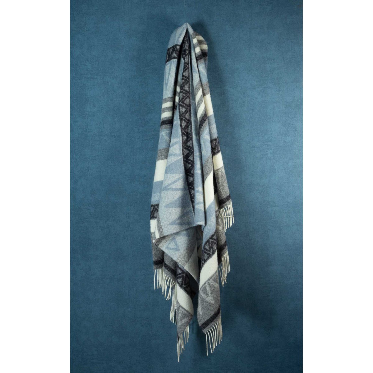 Close-up of Triangel throw's geometric blue and grey weave