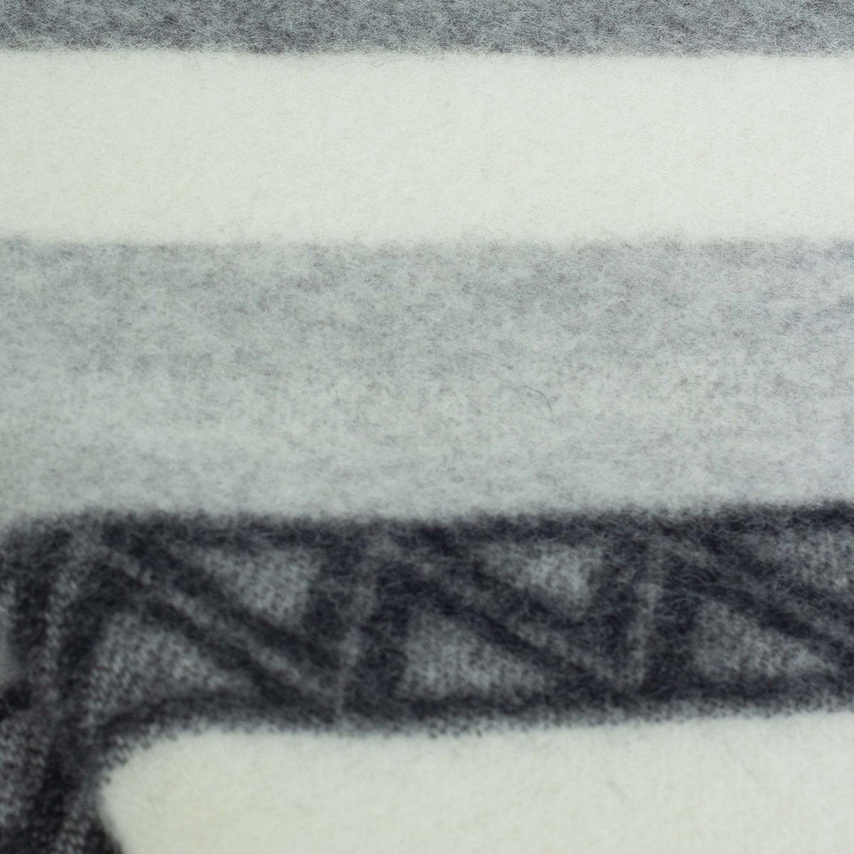 Close-up of Triangel throw's geometric grey and white weave
