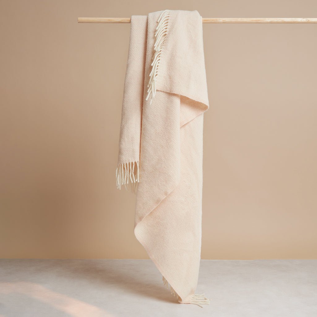Alpaca Merino Throw Blanket hanging fully open to show its fringed edge