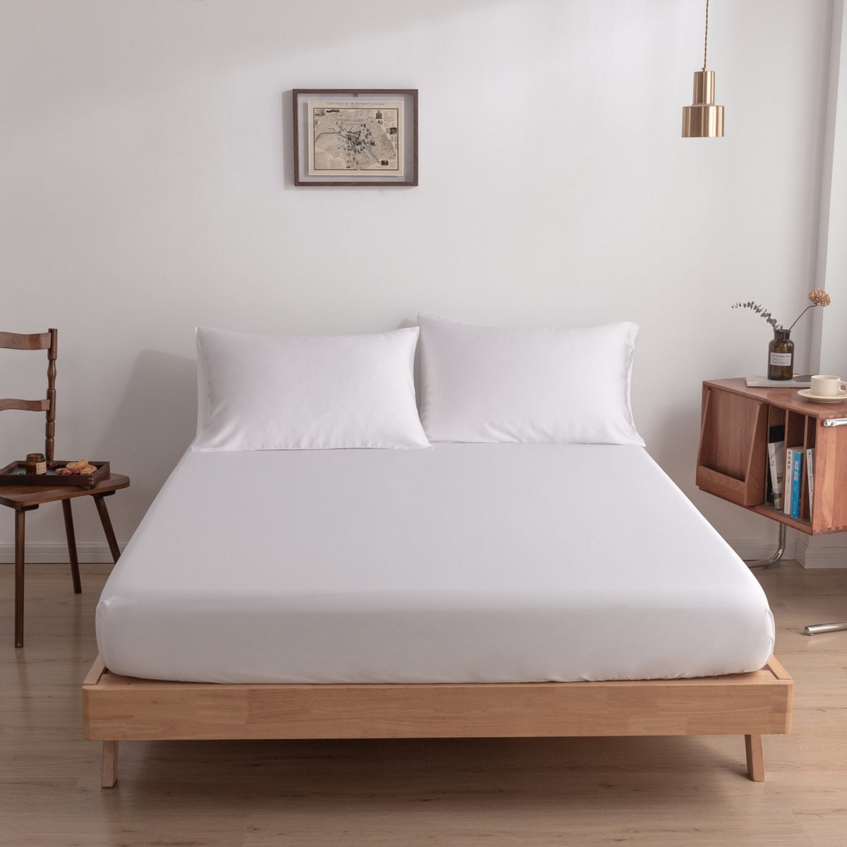 Coco White bamboo bedding set on a bed with a wood frame