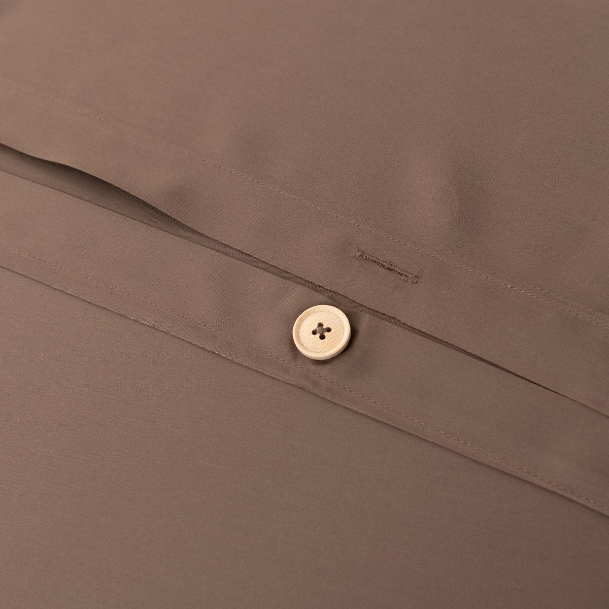 Close-up of the button/tag detail on the Coffee Brown bamboo bedding