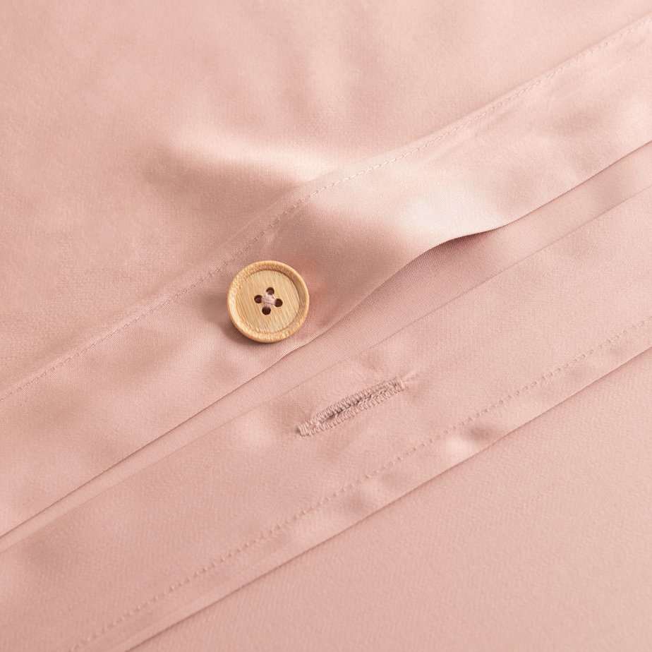 Close-up of the button/tag detail on the Cuddle Pink bamboo bedding