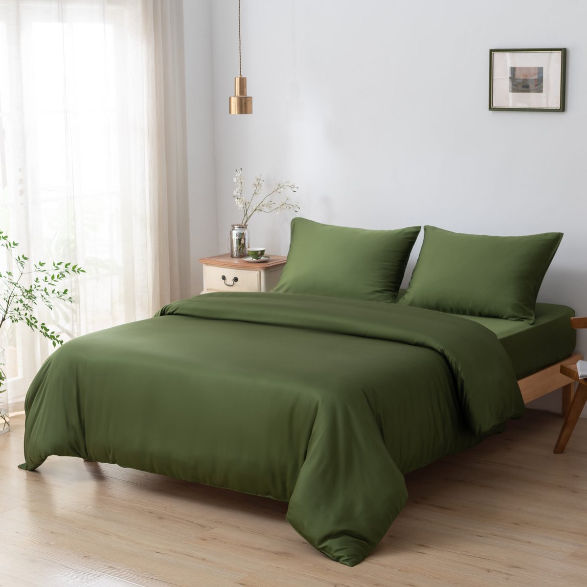 Deep Moss bamboo bedding set styled on a made bed