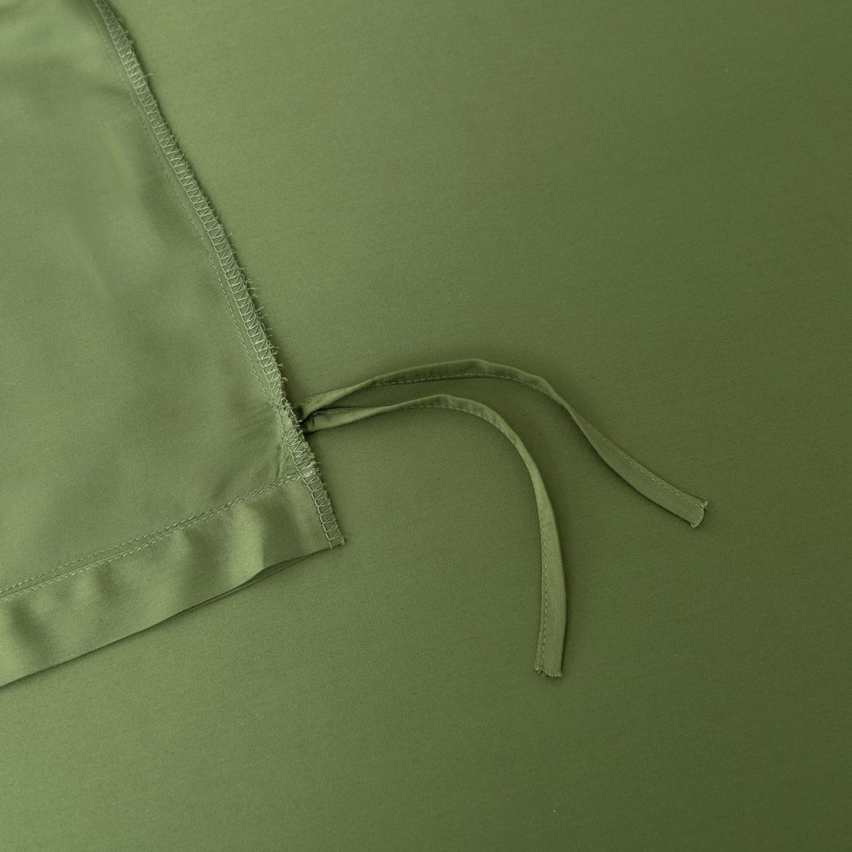 Close-up of a tie/closure detail on the Deep Moss bamboo bedding