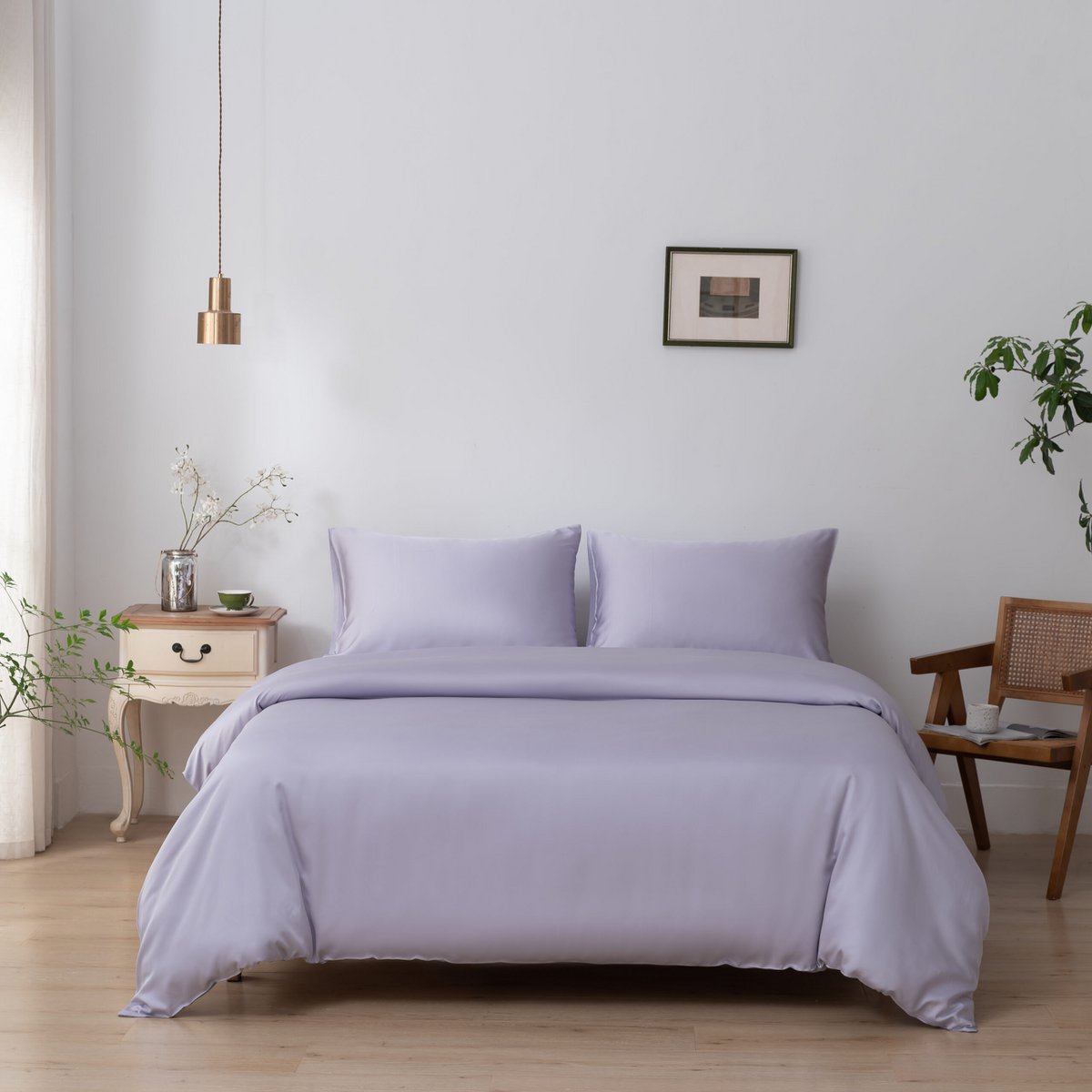 Lavender Mist bamboo bedding set styled in a bedroom with a plant