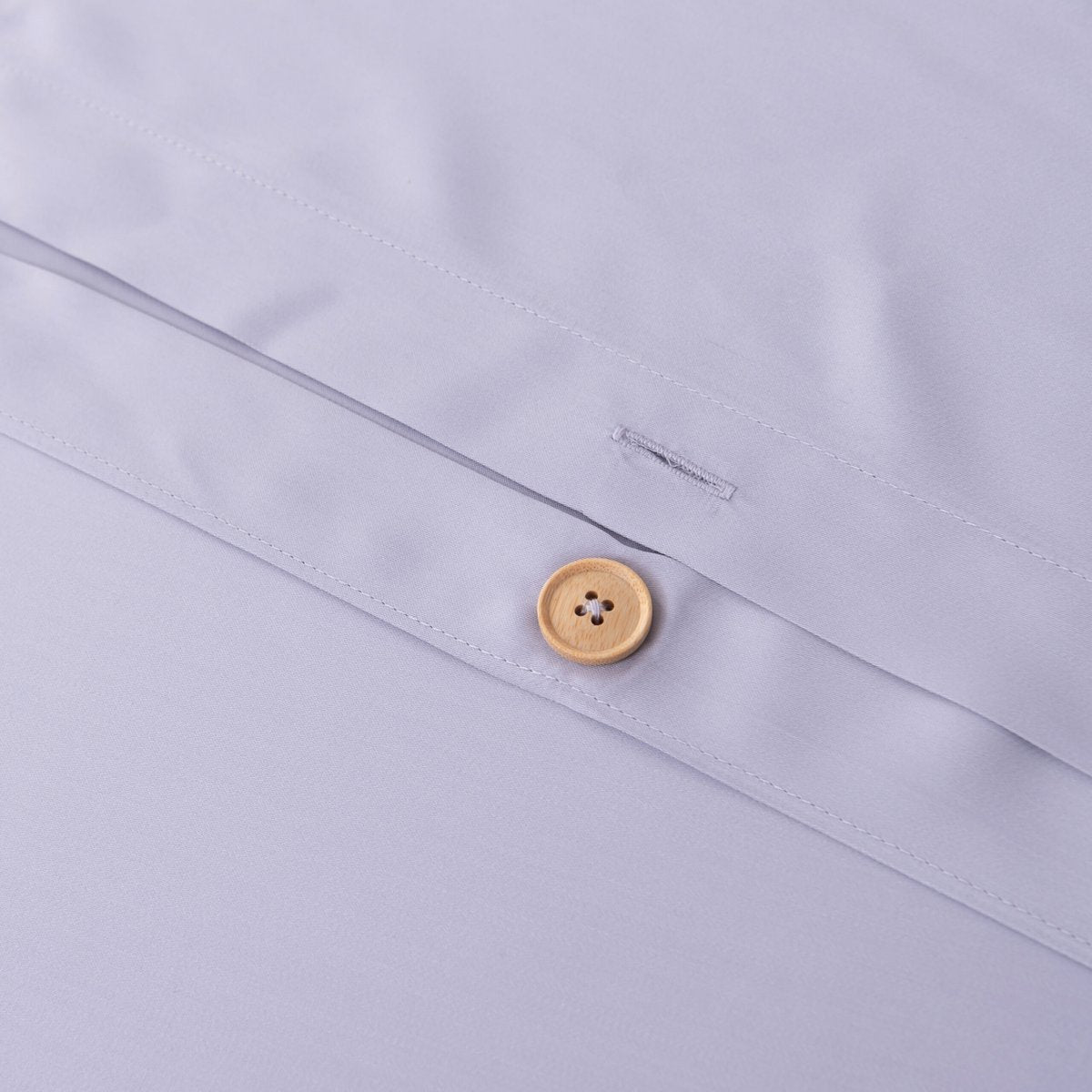 Close-up of the button/tag detail on the Lavender Mist bamboo bedding