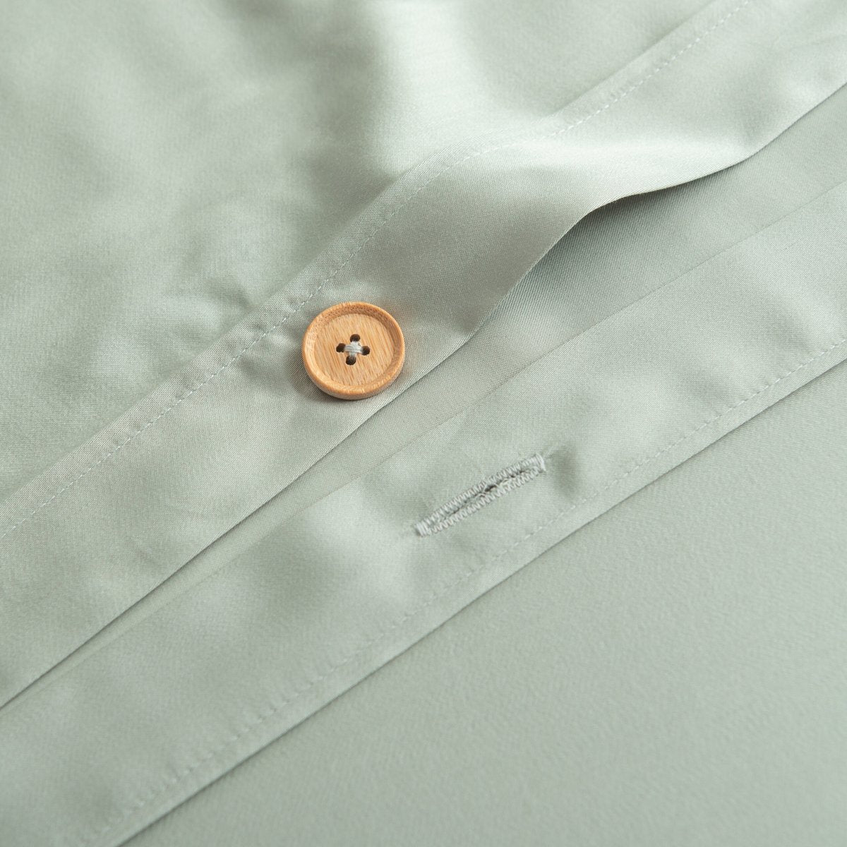 Close-up of the button/tag detail on the Sage Green bamboo bedding