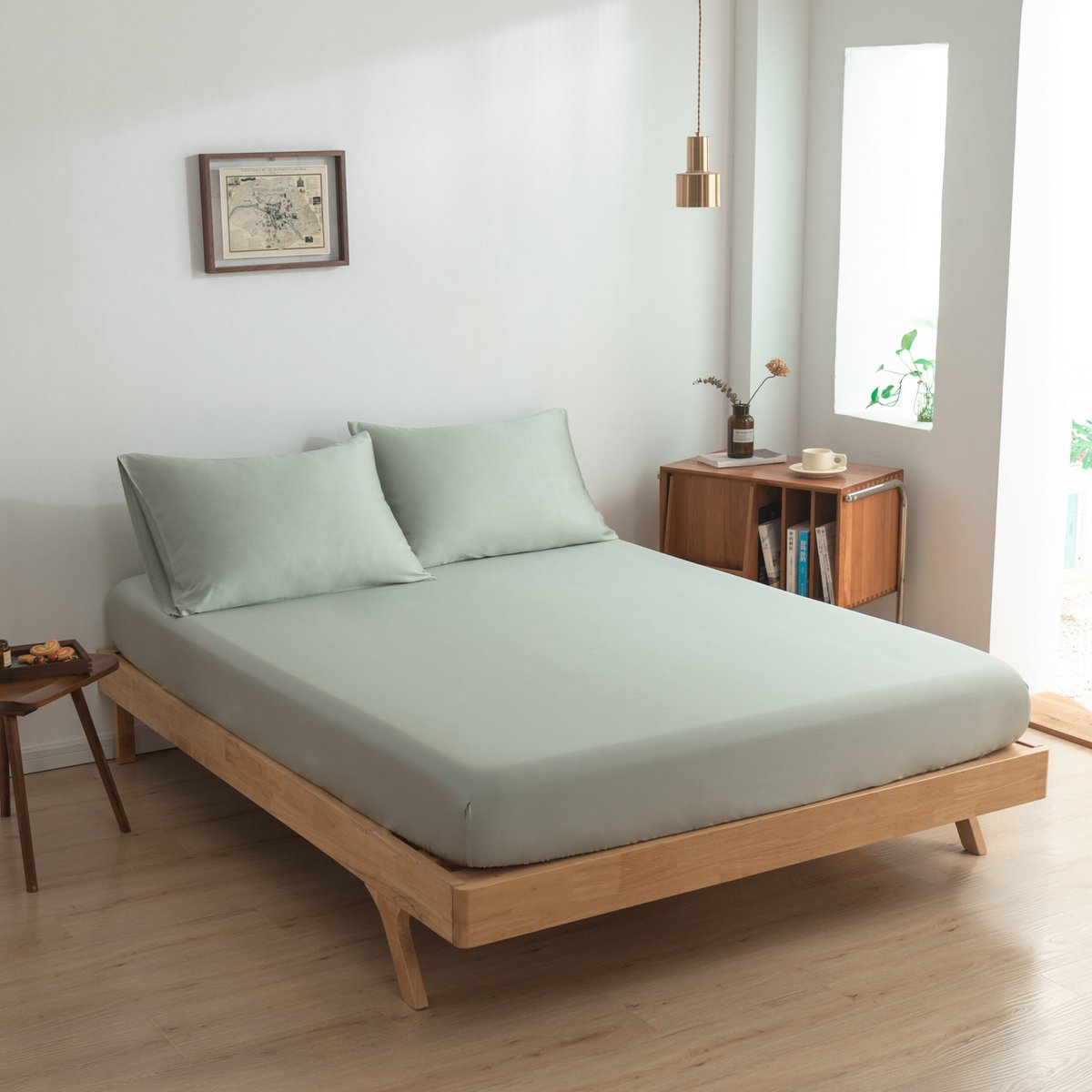 Sage Green bamboo bedding draped over a chair in a bedroom setting
